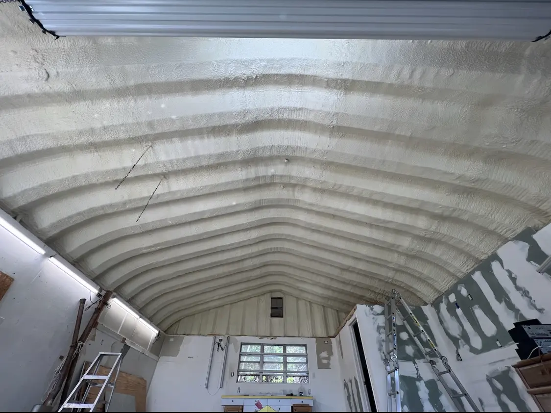 Spray polyurethane foam applied to the underside of a metal roof deck in Massillon